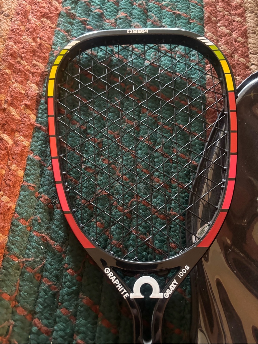 Omega Black Racketball Racket with Red and Yellow Accents - Picture 3 of 6